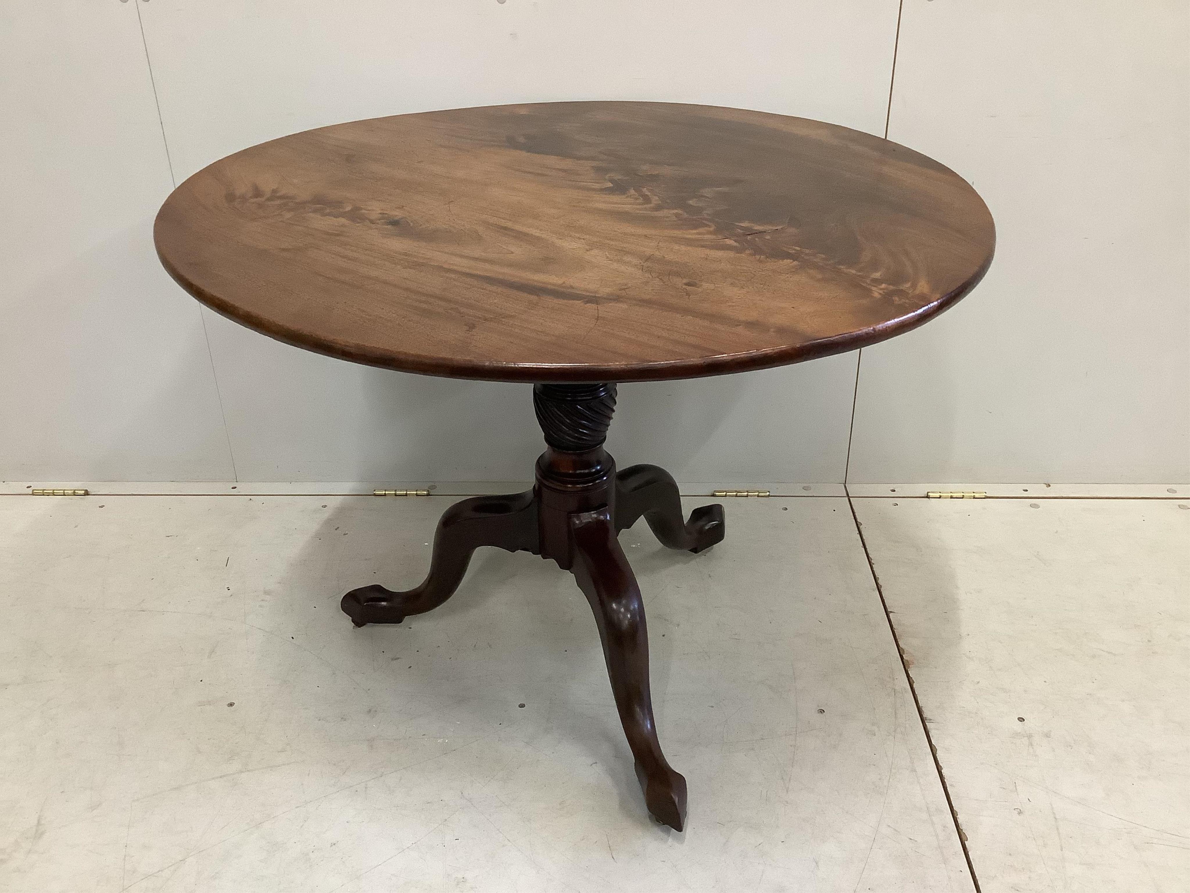 A George III circular mahogany tilt top tripod tea table, diameter 99cm, height 75cm together with four George III mahogany dining chairs. Condition - fair